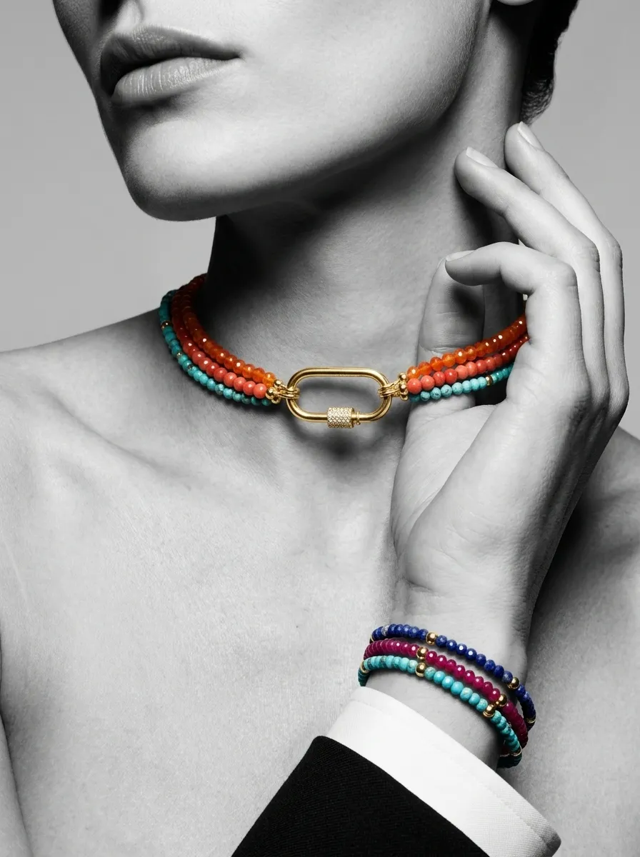 Black and white close-up with a coral and sunstone choker and stacked bracelets